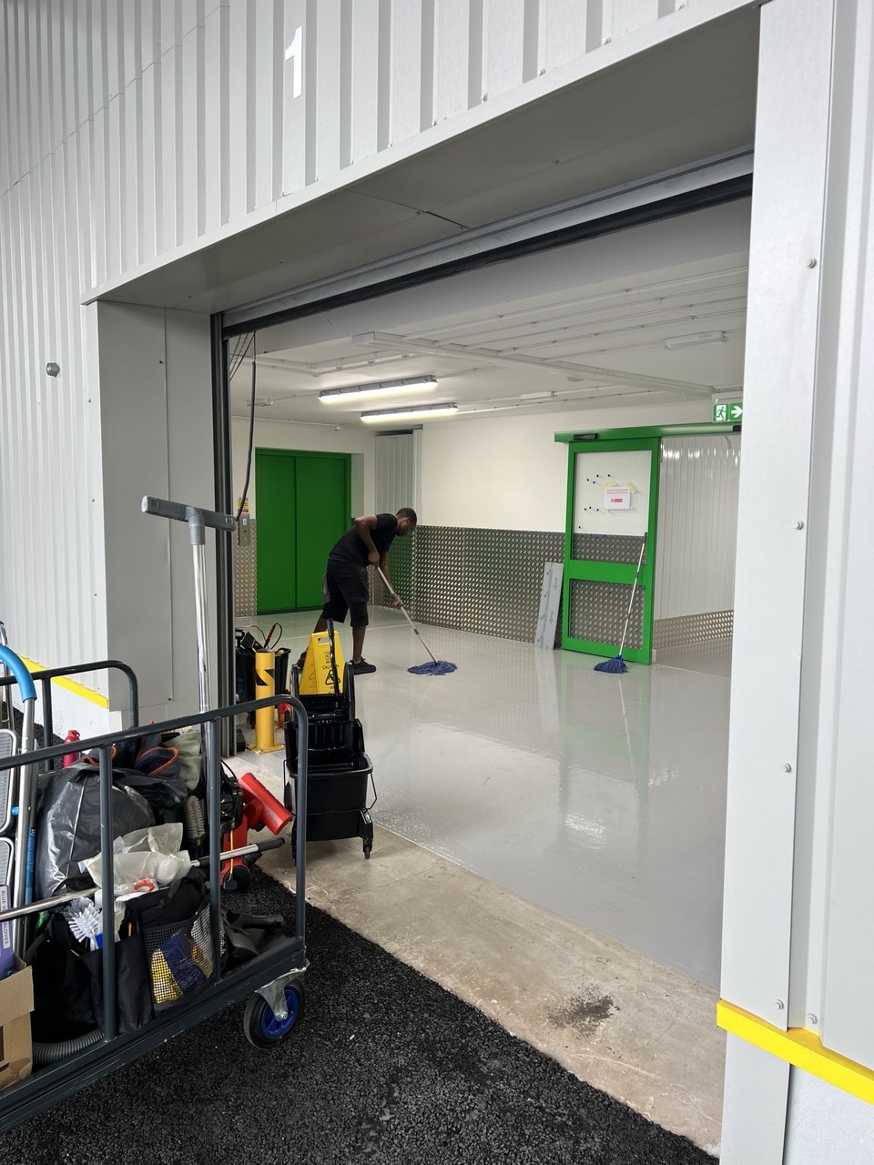 Top Men Cleaning team member working at a commercial facility